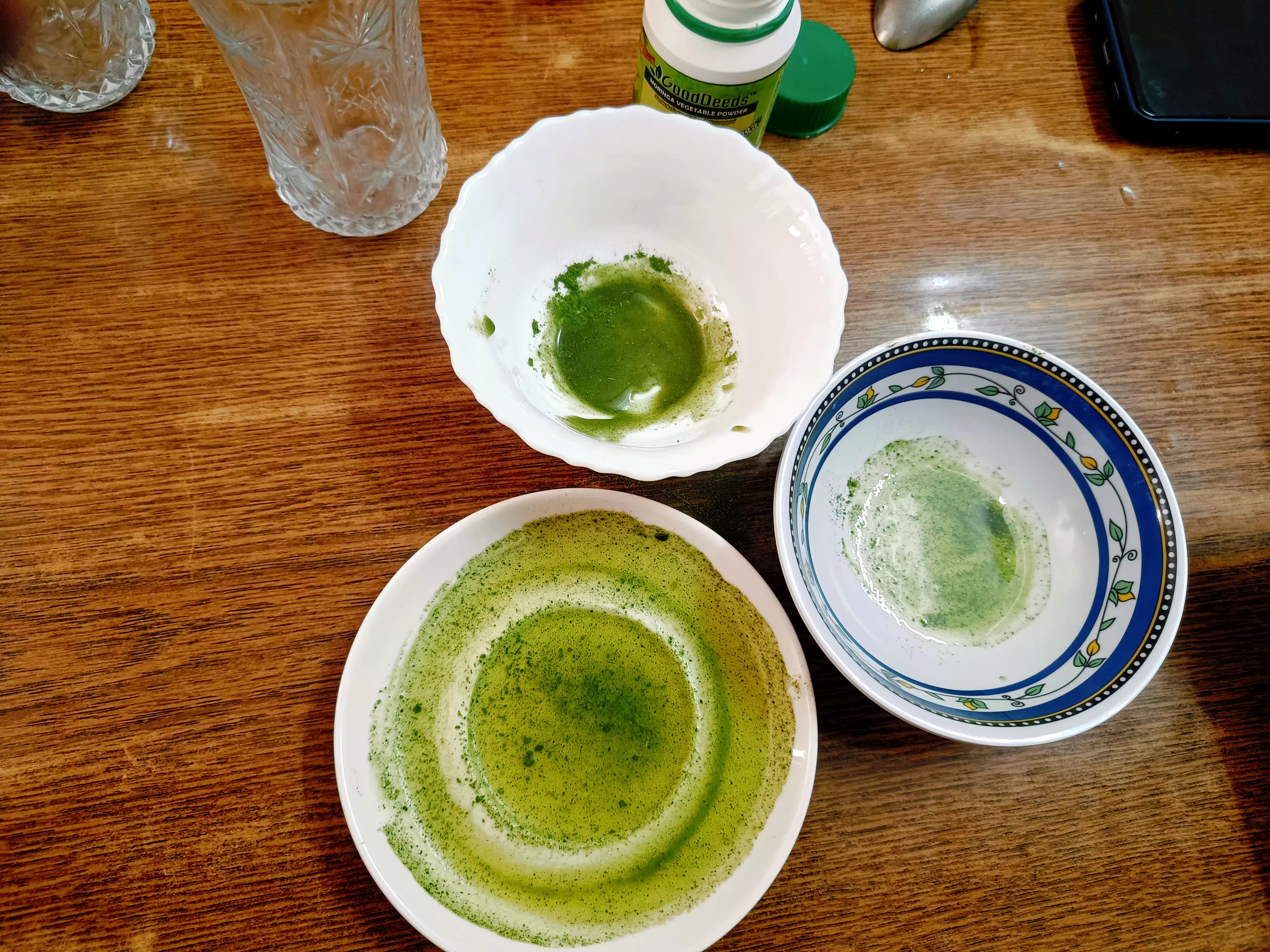 Demonstrating the nature of Moringa powder. With water is separates. With oil and Honey it becomes a new mixture.